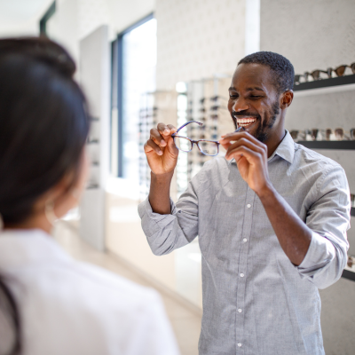 man trying on new glasses in an optometrist's office