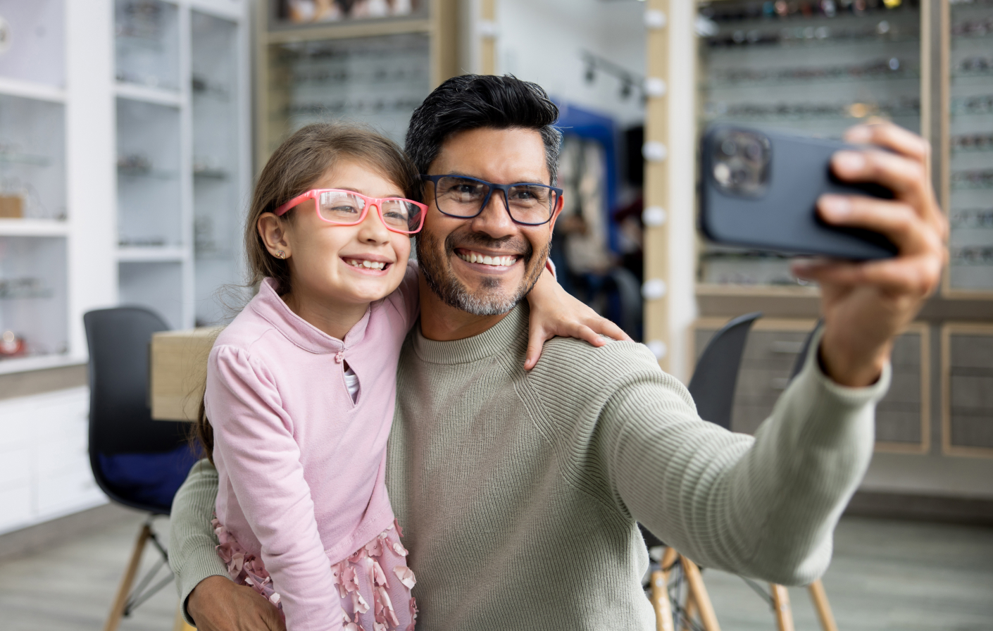 father and daughter smiling taking a photo