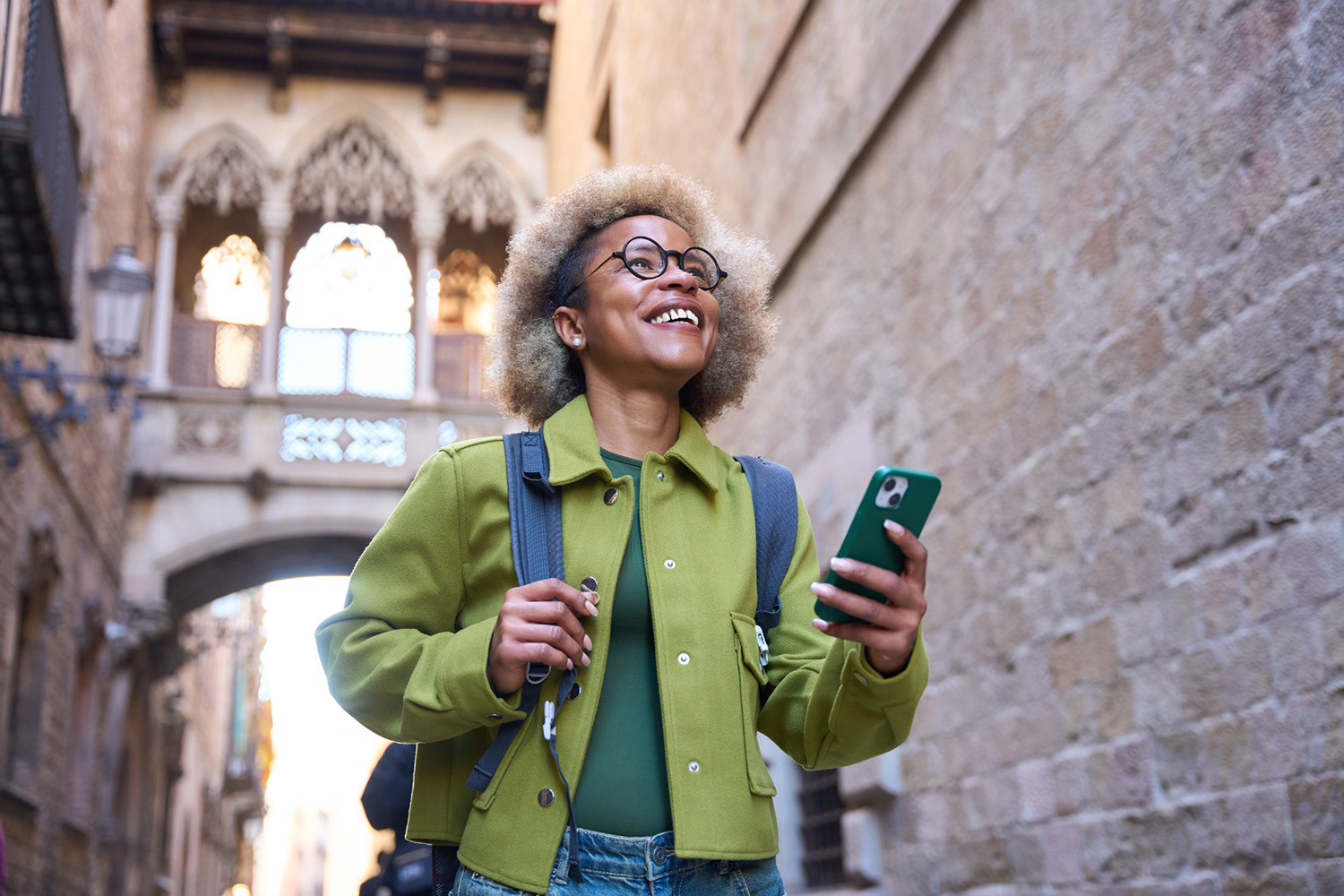 woman wearing glasses looking at directions on her phone