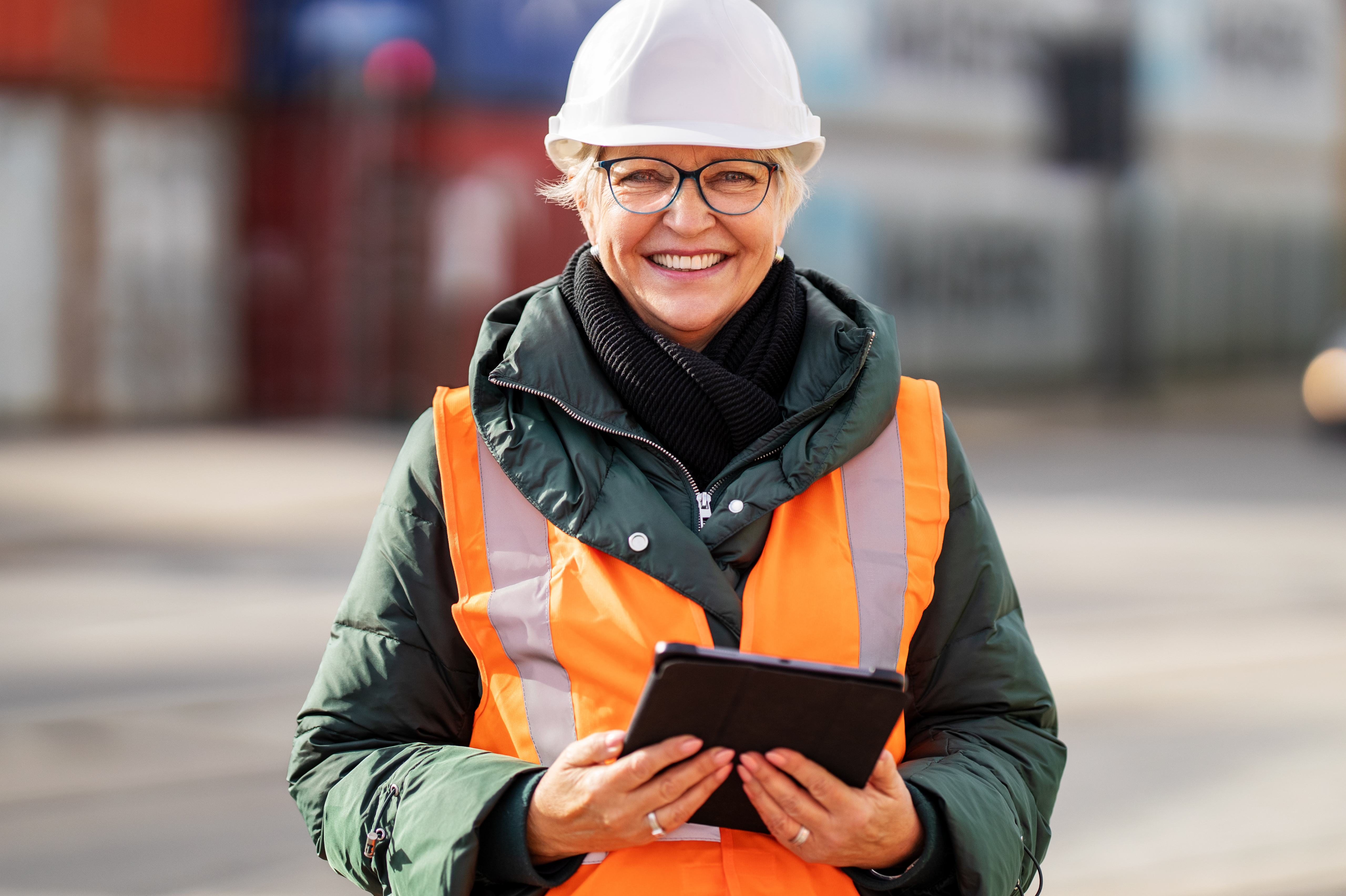 woman on job wearing glasses with ipad