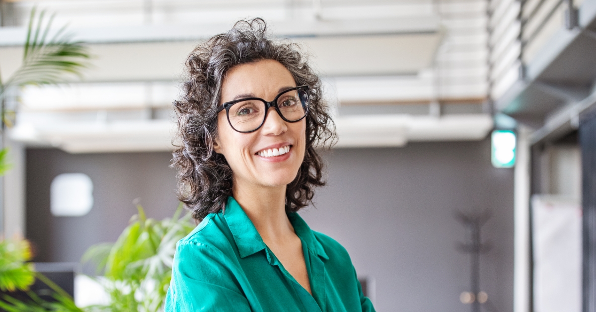woman with glasses smiling