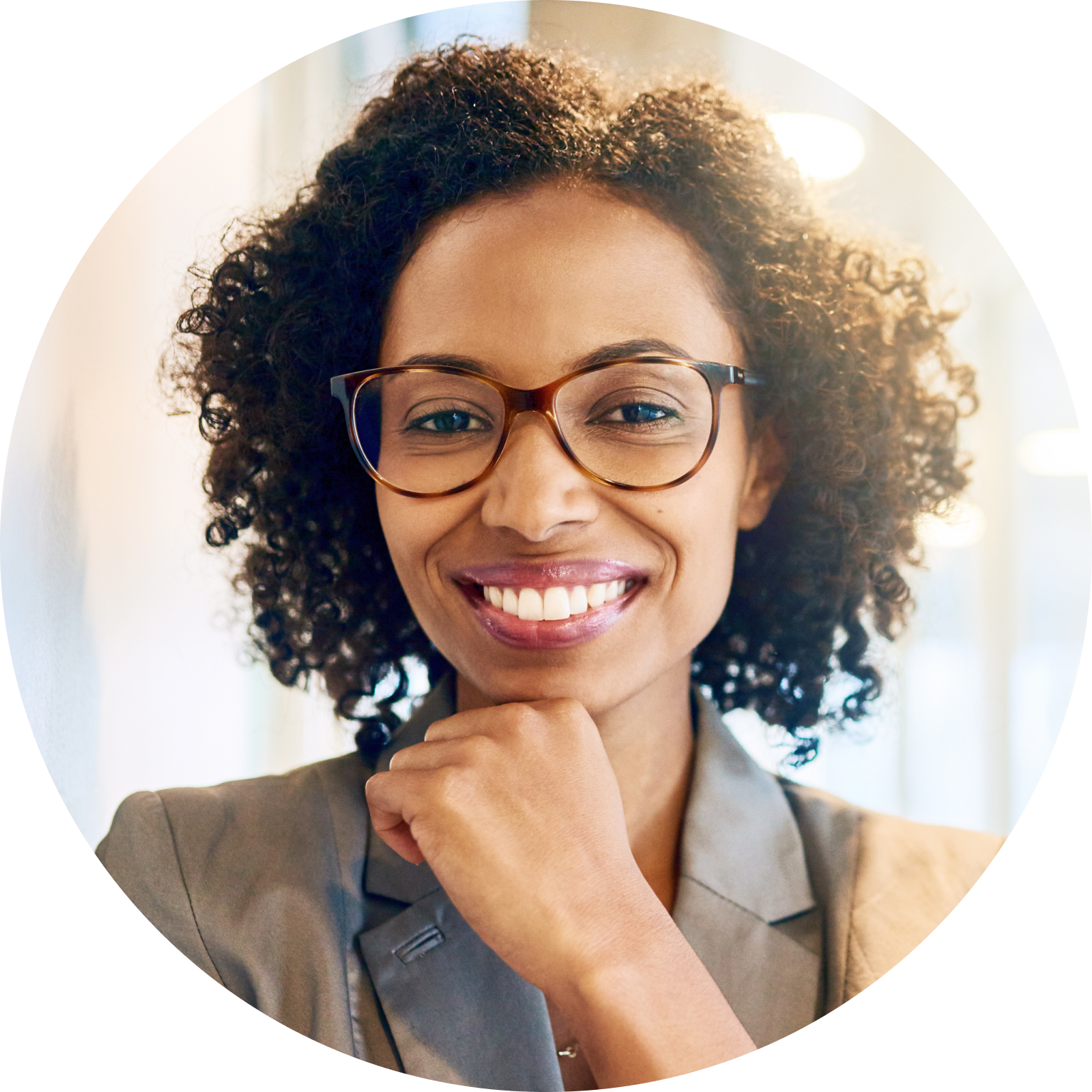 woman in glasses smiling resting chin on hand